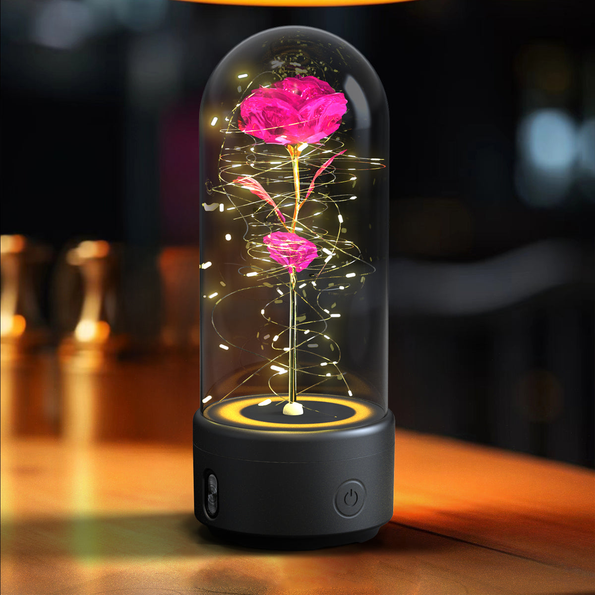 Pink color rose lamp on a black base, lit up