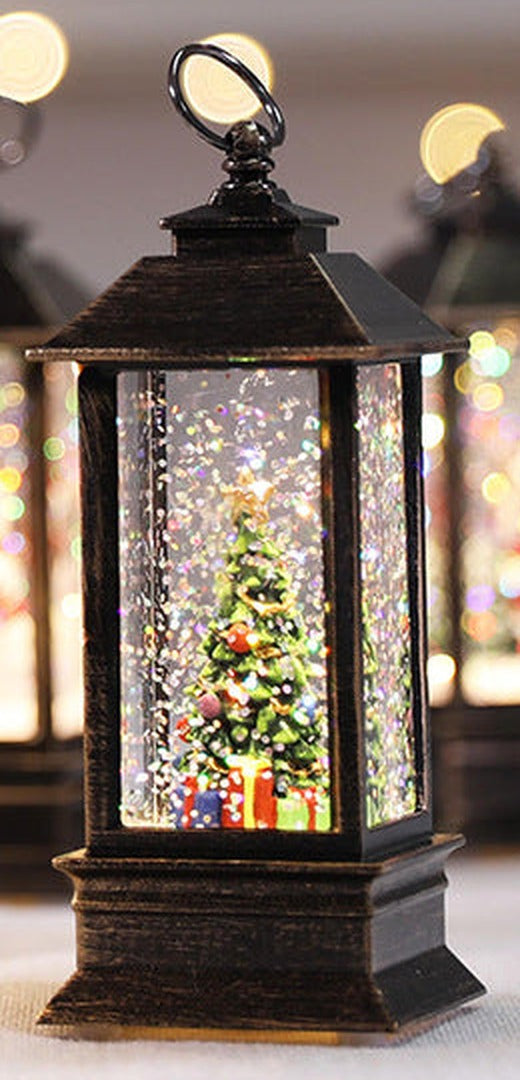 Christmas tree lantern lit up, glitter inside