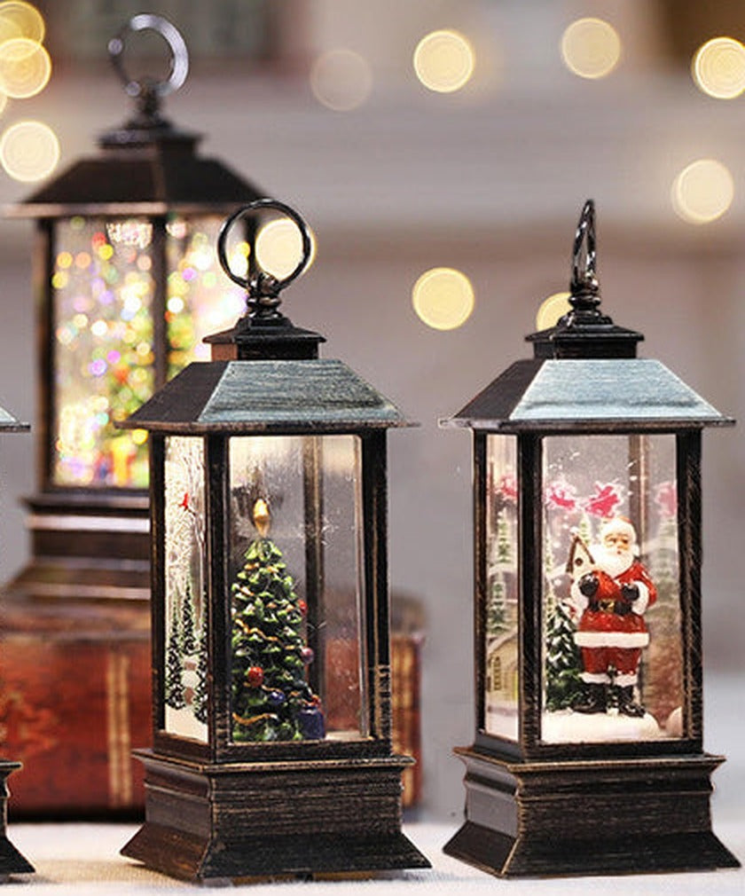 Santa and Christmas tree lanterns on a shelf