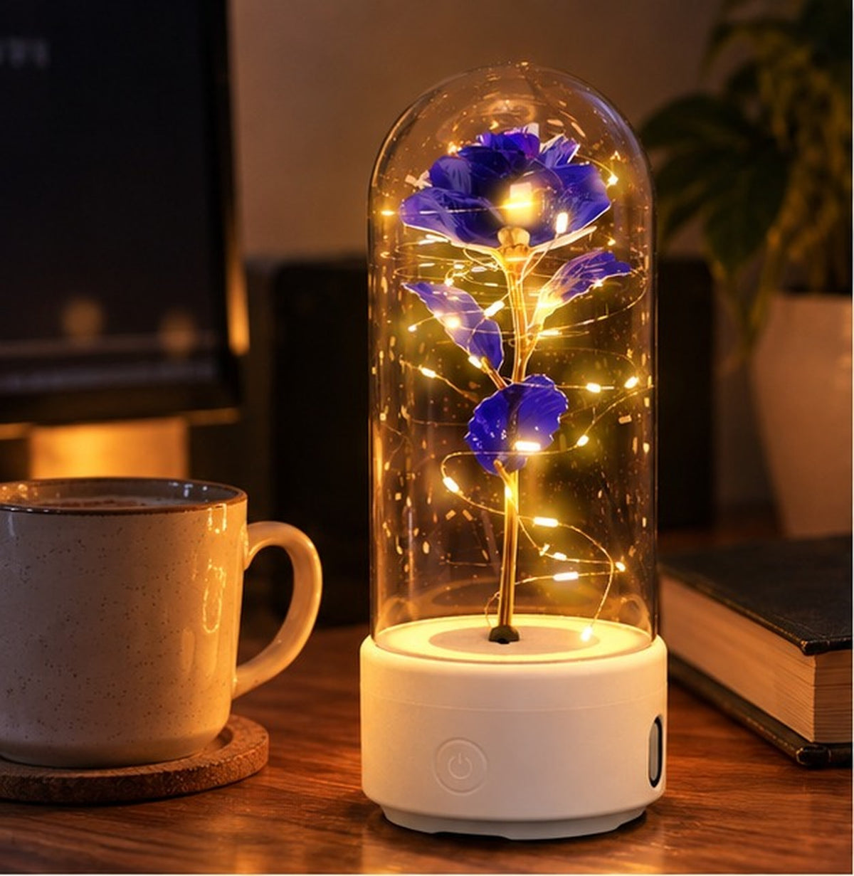 Purple rose lamp on a white base next to a mug