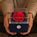 Navy soap rose gift box held in two hands