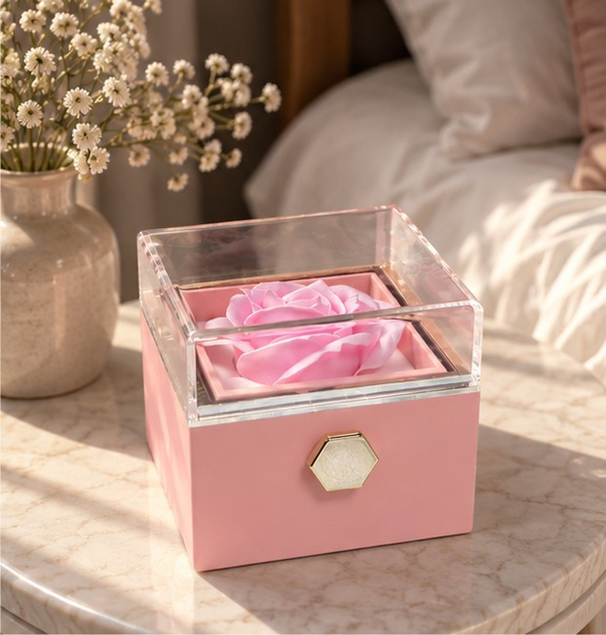 Pink soap rose gift box on a bedside table